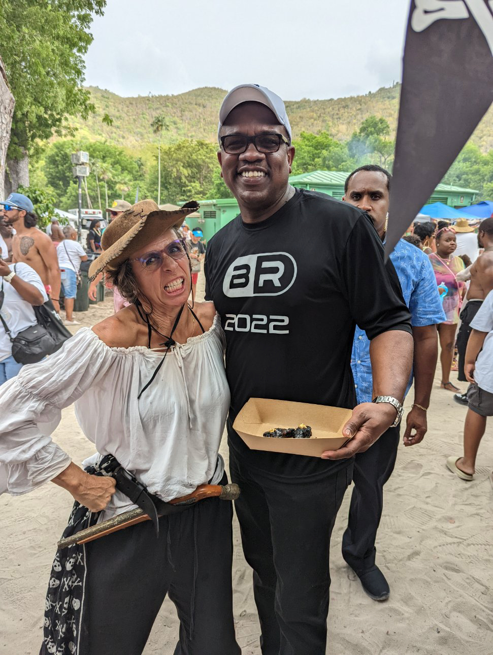 A woman dressed as a pirate poses with a man in black