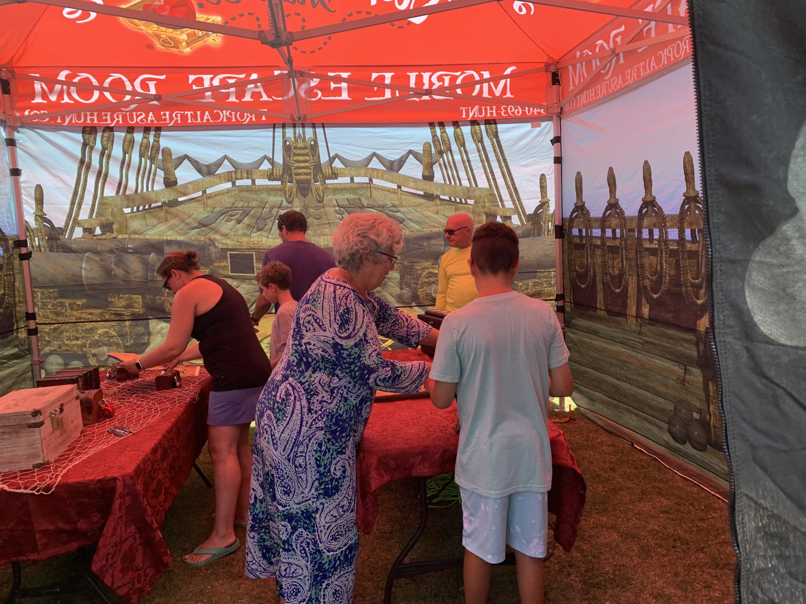 Guests try to solve the puzzles in the Mobile Escape Room Tent
